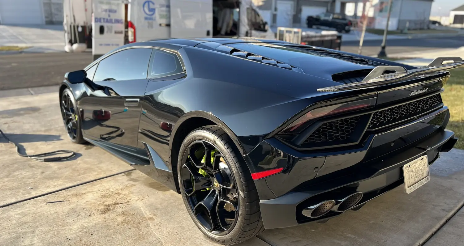 Black Lamborghini with a mirror-like finish after detailing