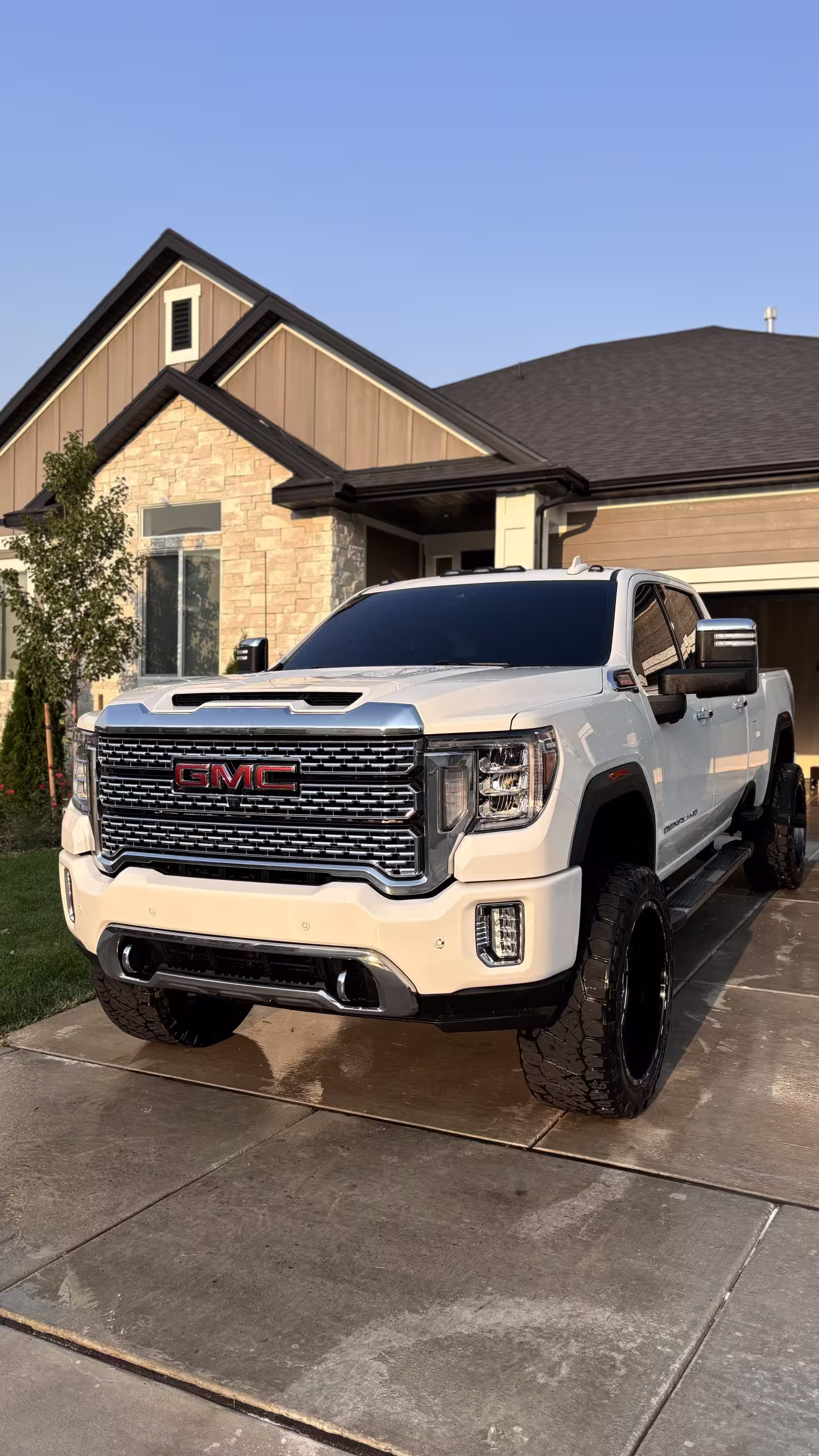 Clean white GMC pickup truck in a residential driveway